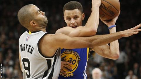 Stephen Curry (right) guarded by Spurs' Tom Parker