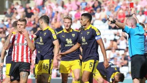 Sunderland midfielder Max Power (left) was given a straight red card for a bad tackle on Oxford United's Marcus Browne