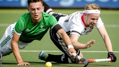 Ireland's Matthew Nelson battles for the ball with Christopher Ruhr of Germany in Amsterdam
