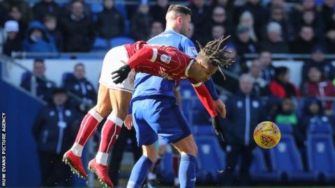 Bobby Reid and Gary Madine challenge for the ball in the air