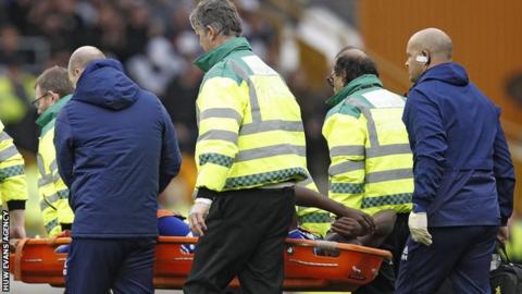 Sol Bamba departs on a stretcher against Wolves in March, 2019