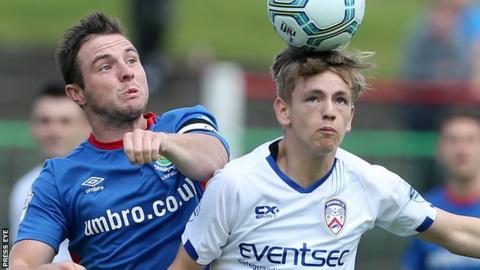 Linfield captain Jamie Mulgrew closes in on Ciaron Harkin in Saturday's win over the Bannsiders