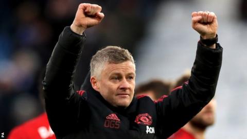 Manchester United interim boss Ole Gunnar Solskjaer raises both fists in celebration after his side beat Leicester