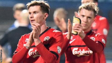 Truro's players acknowledge their fans who made the 626-mile round-trip to Macclesfield