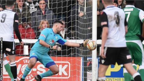 Biggleswade Town goalkeeper Liam Gooch makes a save