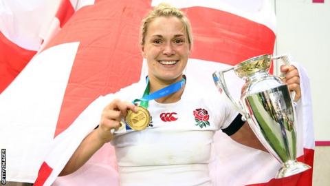Burford poses with the World Cup trophy and her medal
