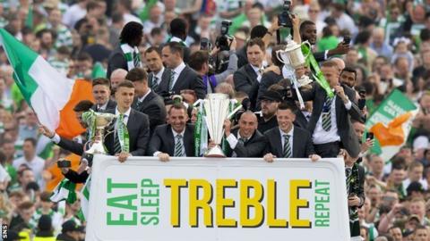 Brendan Rodgers and his squad celebrate winning the 'Double-treble'