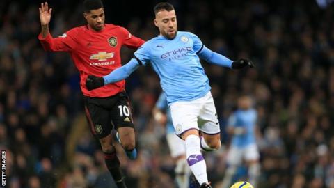 Marcus Rashford and Nicolas Otamendi battle for possession during the Manchester derby in December