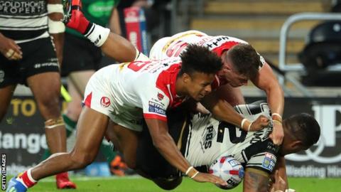 Regan Grace and Morgan Knowles of St Helens tackle Bureta Faraimo of Hull FC during the Super League match between Hull FC and St Helens Saints at the KCOM Stadium