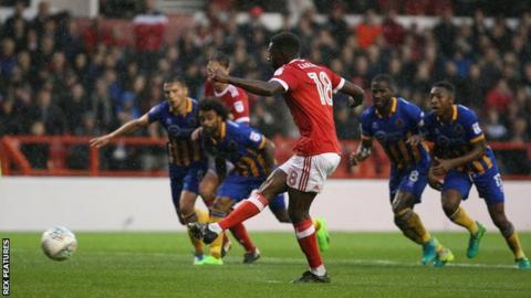 Mustapha Carayol scores from the penalty spot against Shrewsbury