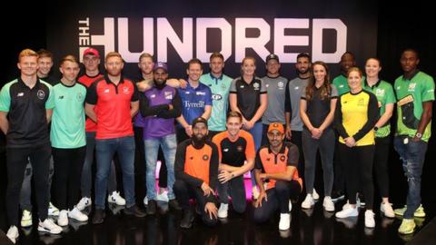 Players including Joe Root, Heather Knight, Ben Stokes and Anya Shrubsole pose in front of The Hundred sign