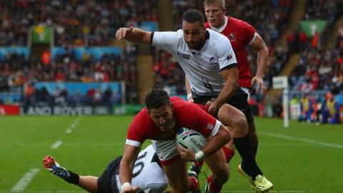 Van Der Merwe of Canada scores the opening try as Madalin Lemnanu of Romania challenges during the 2015 Rugby World Cup
