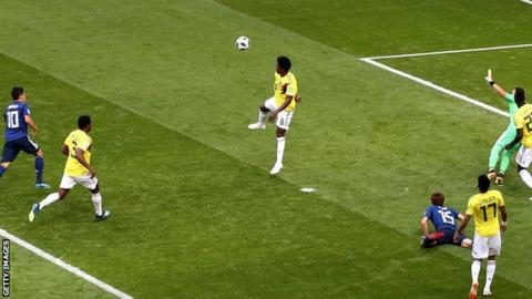 Colombia's Carlos Sanchez handballs against Japan