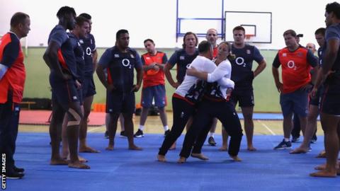England players watch instructors