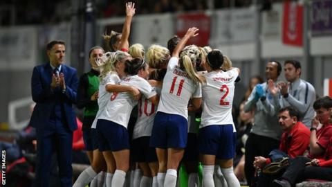 England women celebrate after beating Wales