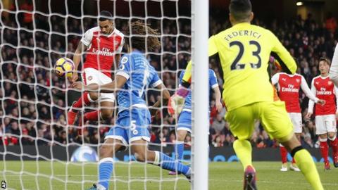 Theo Walcott heads in for Arsenal against Bournemouth