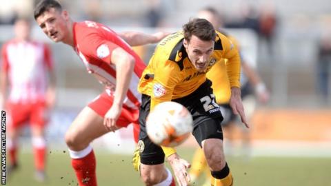 Alex Rodman of Newport County gets away from Matty Pearson