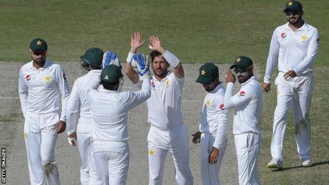 Pakistan leg-spinner Yasir Shah high-fives a team-mate in celebration after taking a wicket in the second Test against New Zealand