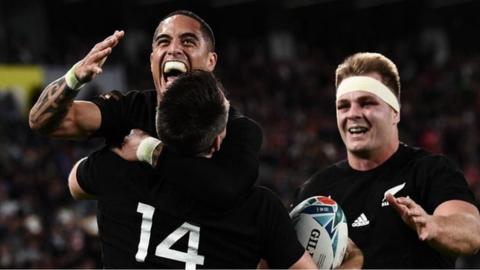 Sam Cane celebrates a try with Aaron Smith and Ben Smith at the World Cup