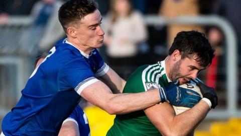 Gaoth Dobhair's Odhran MacNiallais protects the ball from Naomh Conaill's Ciaran Thompson