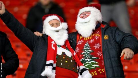 Football spectators wearing their festive jumpers