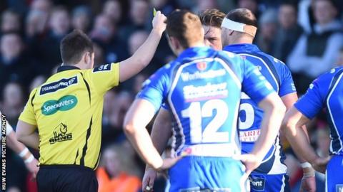 Referee Ben Whitehouse shows a yellow card to Newport Gwent Dragons lock Rynard Landman