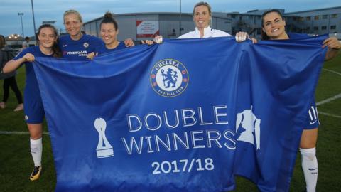Chelsea players hold up a flag which reads Double Winners 2017/18 below an image of the club's crest