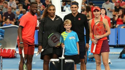 The players line-up for a photo before the match