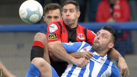 Sean Wards outmuscles Coleraine striker Eoin Bradley in a tussle for the ball