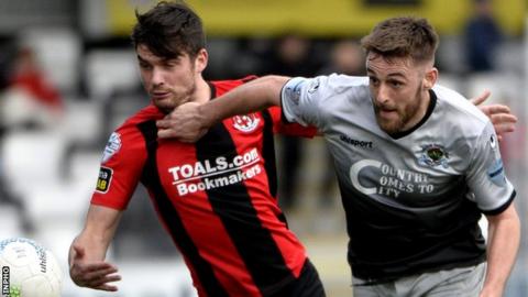 Philip Lowry of Crusaders in action against Institute's Niall Grace
