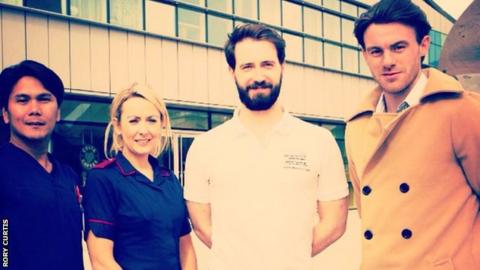 Rory Curtis and three other people pose for a photo as they raise money for charity