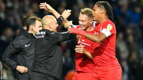 Two-goal Barnsley hero Cauley Woodrow (right centre) went to celebrate his opening strike at The Hawthorns with caretaker boss Adam Murray