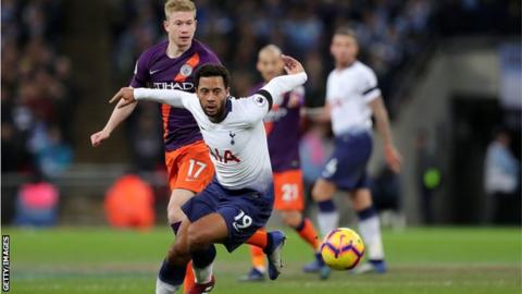 Tottenham midfielder Mousa Dembele goes to play the ball while shielding it away from Manchester City midfielder Kevin de Bruyne