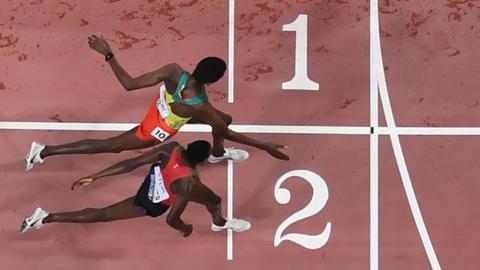 Kenya's Conselsius Kipruto crosses the finish line and wins next to second-placed Ethiopia's Lamecha Girma