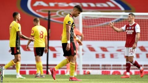 Watford players look dejected after defeat by Arsenal on Sunday