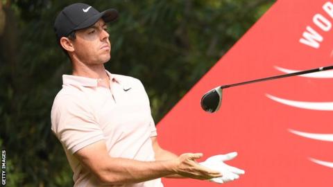 Rory McIlroy lets go of his club after his drive at the ninth tee