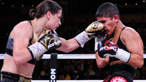 Katie Taylor (left) lands a left on Cindy Serrano in Boston in October