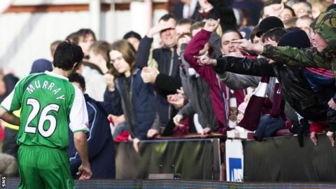 Ian Murray retrieves a ball from in front of Hearts supporters at Tynecastle