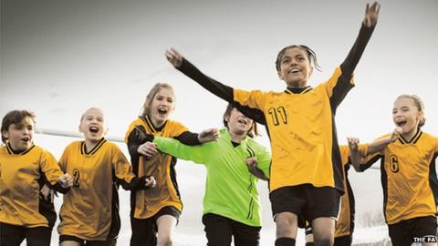 girls football team celebrating