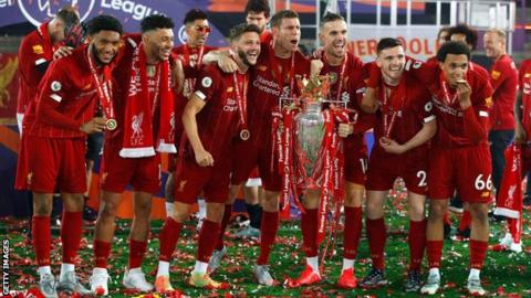 Liverpool players celebrate with the Premier League trophy