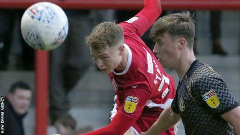 George Tanner of Morecambe clears from George Nurse of Newport County
