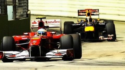 Ferrari driver Fernando Alonso with Red Bull's Sebastian Vettel just behind him at the Singapore Grand Prix