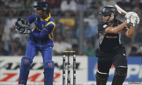 New Zealand's Ross Taylor plays a shot next to Sri Lanka's captain and wicketkeeper Kumar Sangakkara