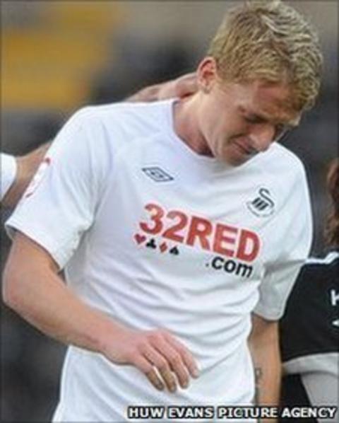 Garry Monk leaves the field after suffering a knee injury against Colchester