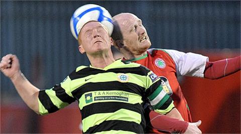 Stephen McAlorum of Donegal Celtic competes for a high ball with Cliftonville's Ryan Catney
