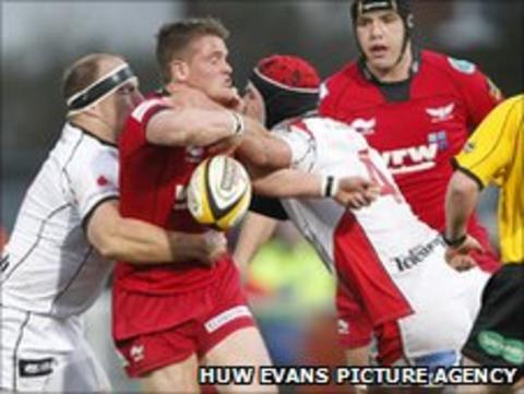 Scarlets' Tavis Knoyle is tackled during the game at Ravenhill