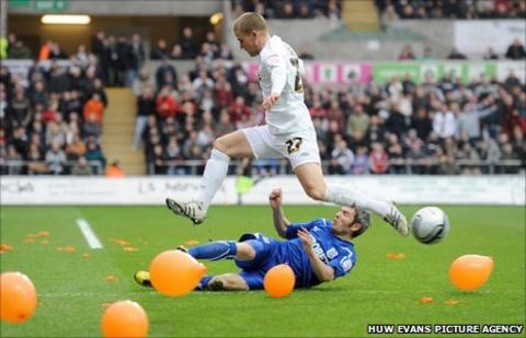 Kevin McNaughton tackles Swansea's Mark Gower