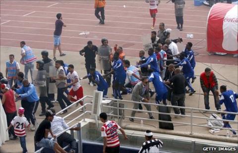Players of Al Hilal run for shelter