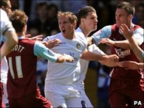 Leeds United's Neil Kilkenny confronts Burnley's Chris McCann