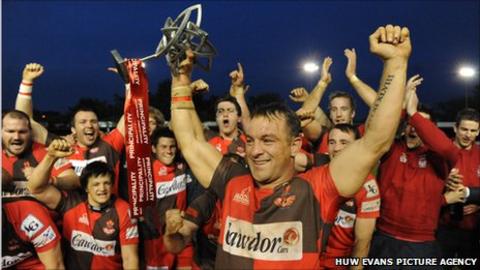Llanelli captain Craig Hawkins lifts the Welsh Premiership title